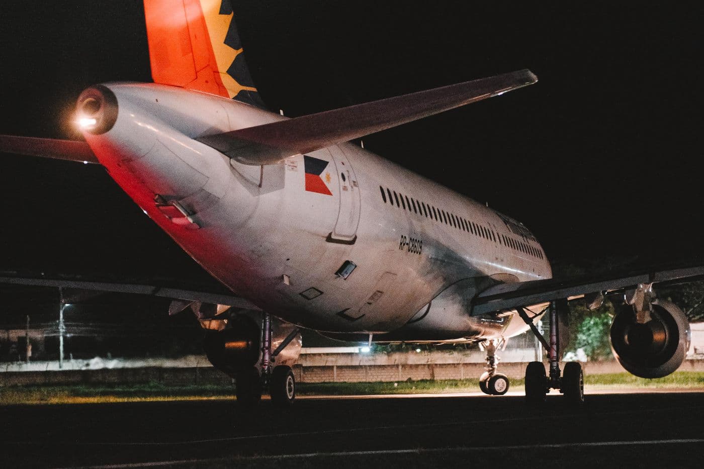 A parked aircraft and ground equipment at night